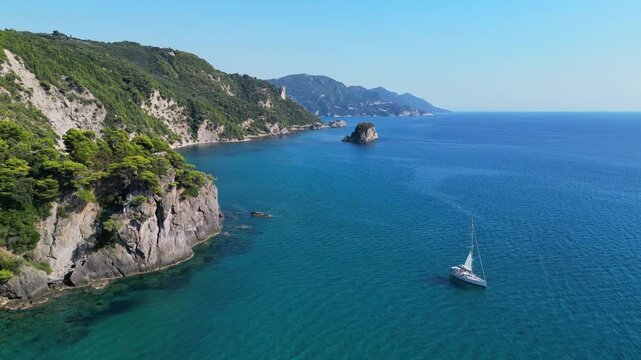 Aerial video of blue sea and a yacht boat sailing around Corfu Island, Greece