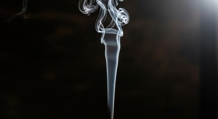 Wispy white smoke curls upward against a dark background.