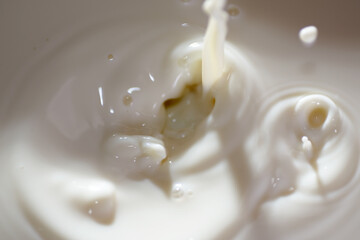 Top view of hot milk splash as background
