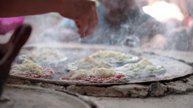 Mexican food, corn gorditas or sopes preparing on a comal