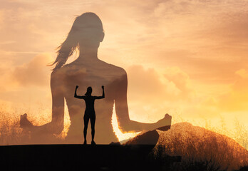 Silhouetted woman sits meditating in a peaceful sunset, image of an empowered person raising arms on a mountain top. Evokes strength, calm, and inner strength mental growth.	
