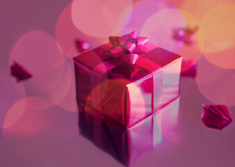 Neatly wrapped gift in pink wrapping and ribbon  