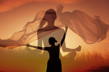 Meditation and Empowerment Double Exposure at Sunset, Woman meditating overlaid with a happy joyful figure holding cloth in the wind, creating a sense of freedom, mindfulness, and energy	