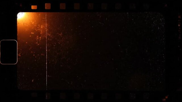 Old celluloid film frame in darkness