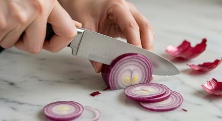 Hands slicing red onion rings on a marble countertop cooking food preparation