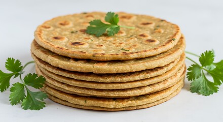 Stack of golden brown flatbreads with fresh cilantro garnish roti chapati