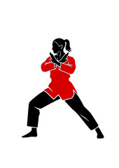 Female Taekwondo athlete in defensive stance ready to fight.