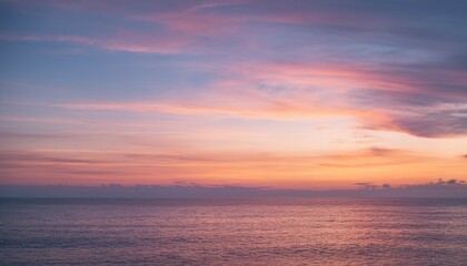 Fototapeta premium Evening sky with pink cirrus clouds over calm ocean water at sunset 