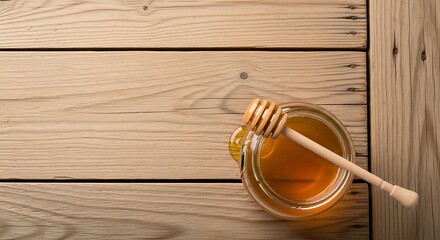 Golden honey in a glass jar with a wooden dipper resting on a rustic table