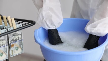 Money laundering. Woman washing dollar banknote in basin indoors, closeup