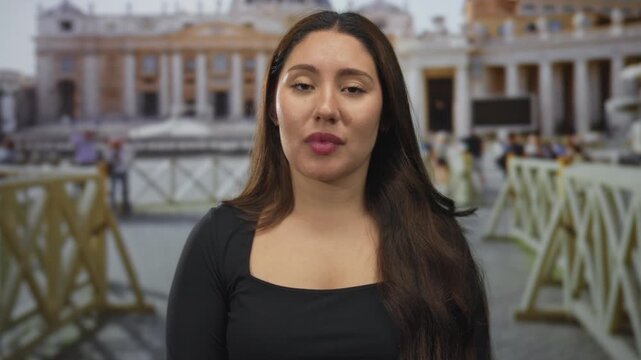 Young hispanic woman covers ears with both hands and closes eyes in vatican square amid st peter building facade; annoyance.