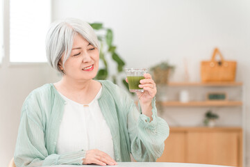 Senior women drinking green juice, green smoothies, and vegetable juice for health

