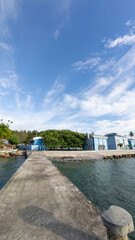 Obraz premium Dock Leading to Blue Building by the Water