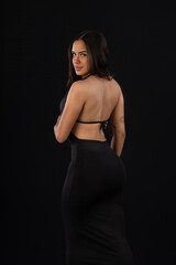 Naklejka premium young woman in sexy red dress in studio photo with black background