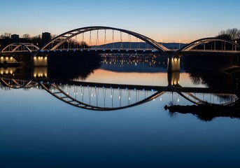 Naklejka premium Serene cityscape reflecting in the water under the twilight sky