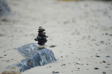 Balanced stack of stones on the beach symbolizing peace, balance, and mindfulness in a natural seaside setting