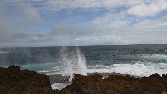 rugged landscape of the rocky cliffs at Quobba Blow Holes, Macleod, Western Australia, along the coastline of the indian Ocean in West Australia with waves crushing ashore.