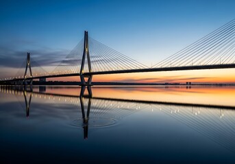 Obraz premium Majestic cable stayed bridge spanning calm waters at dawn serenity