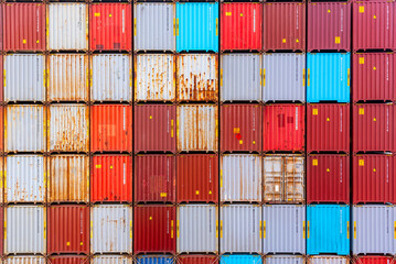 Fototapeta premium Stacks of intermodal freight containers form a regular grid pattern. 