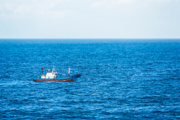 A fishing boat navigates the vast waters near the Chinese coast. 