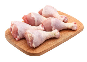 raw chicken drumsticks on wooden cutting board.