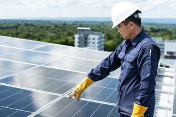 Engineer checking inspection solar cells on the roof.Technician maintaining solar panels on blue sky and white clouds background.Solar photovoltaic panel system and saving energy with clean power.
