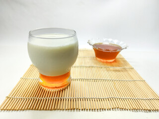 Healthy Breakfast A Glass of Nutritious Milk with Sweet Honey on a Bamboo Mat