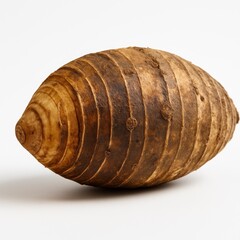 Whole taro corm with intact fibrous root base lightly trimmed isolated on white clean studio vegetable detail for cooking markets and nutrition