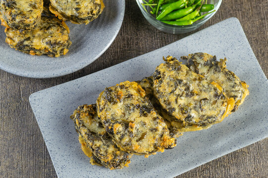 rolade tahu daun singkong is a savory fried dish made from a mixture of tofu, cassava leaves and spices, then shaped and fried. indonesia food. top view food