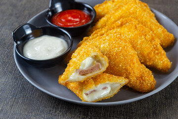 roti goreng mayo, savory snack made from white bread coated with breadcrumbs and fried until crispy, then filled with a mixture of mayonnaise and other ingredients such as sausage, cheese or others