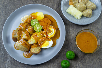 Siomay (also somai) is a Chinese-Indonesian steamed fish dumpling with vegetables served in peanut sauce