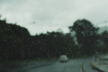 Traveling on a rainy day. Rain on the windshield while traffic jams.