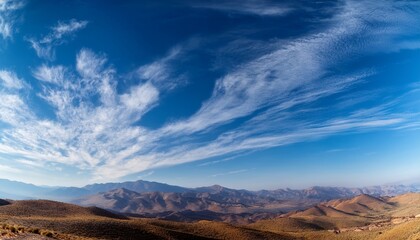 Fototapeta premium Blue Sky with Cirrus Clouds and Mountain Silhouette 