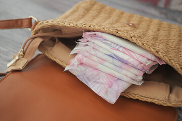 Packing feminine hygiene products in a woven bag