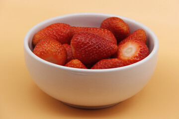 MANY STRAWBERRIES IN A WHITE BOWL ISOLATED