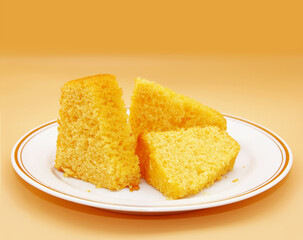 SOFT CORN FLOUR CAKE WITH CARROTS ON A TRANSPARENT PLATE ON AN ISOLATED BACKGROUND