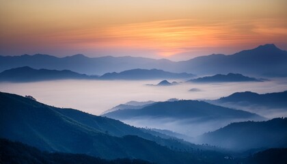Fototapeta premium Misty Evening Mountains with Sunlight Streaming Through Fog 