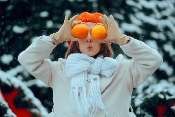 Cheerful Woman Holds Two Oranges in Front of Her Eyes. Lady boosting her immune system with vitamin...