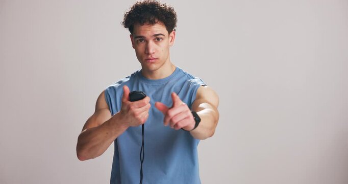 Instructor, face and man with stopwatch in studio for interval training, monitor fitness and guide. Mockup space, personal trainer and timer on white background for progress tracking and performance