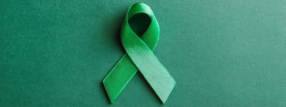 World bipolar day. Green ribbon on green background. Mental health awareness day, Depression, Cerebral palsy. World kidney day.