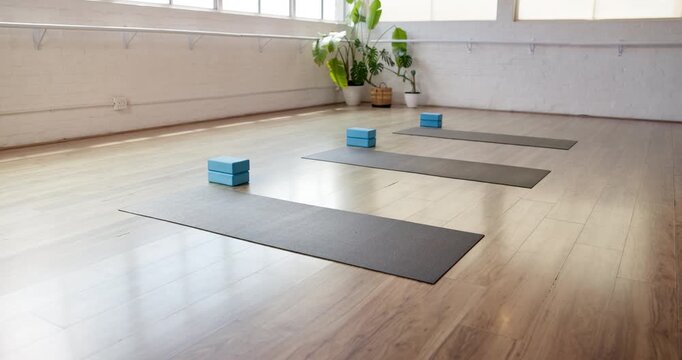 Fitness, start and mat in gym on floor, preparation and equipment for body wellness class. Yoga, empty room and setup in studio with support blocks, workout group or beginning of pilates training.