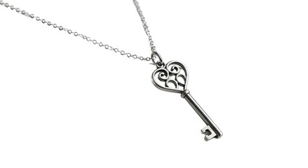 Fototapeta premium Heart shaped key pendant on silver chain isolated on white background