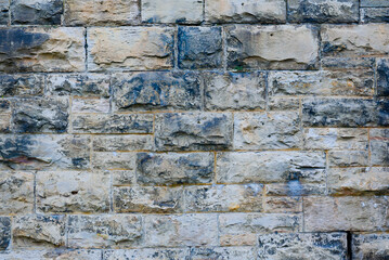 Rows of multicolored stones arranged in a line, ideal for building strong and durable structures.