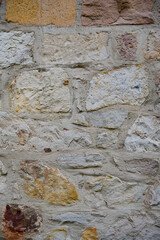 Rows of multicolored stones arranged in a line, ideal for building strong and durable structures.