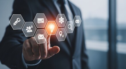 Businessman interacts with futuristic digital interface displaying business icons