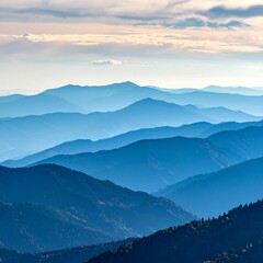 Fototapeta premium Layered blue mountains under a cloudy sky
