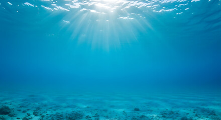Underwater Ocean Background with Sun Rays and Sandy Bottom, Deep Blue Water and Light Beams Penetrating the Surface