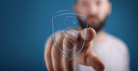 Hand pointing at digital shield with paragraph symbol, representing legal protection, data...