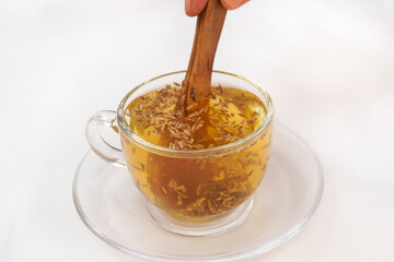 Common cumin or zeera or jeera in a bowl isolated on white with its extracted water in a bowl.; Herbal detox weight loss water.