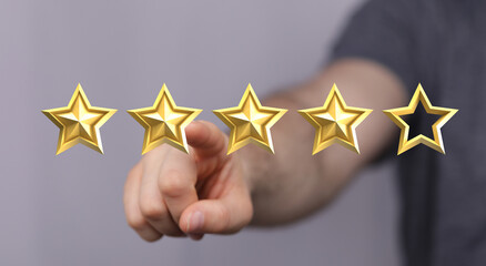 Hand pointing to a rating with four golden stars, symbolizing customer satisfaction, review, and product quality. Ideal for showcasing positive